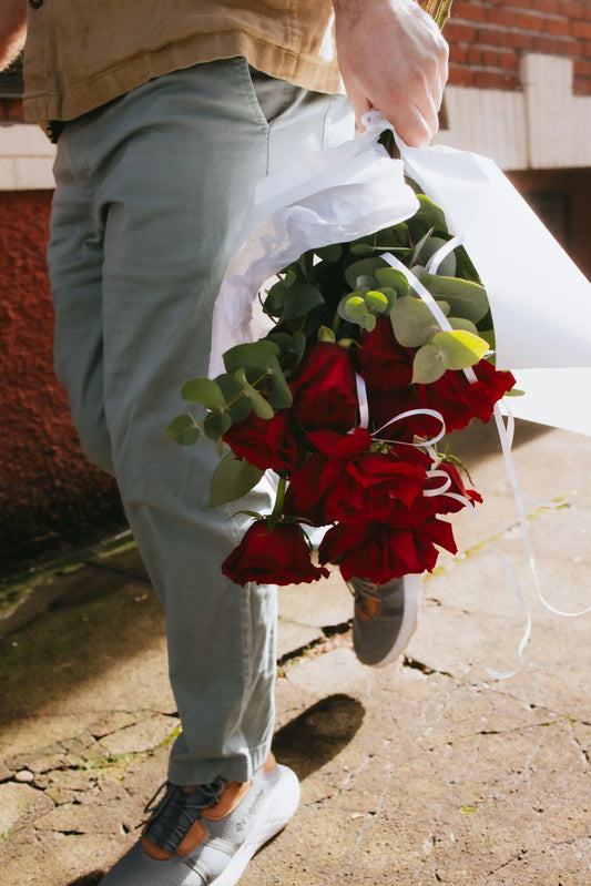 Man carrying Valentine red roses bouquet on Portland street