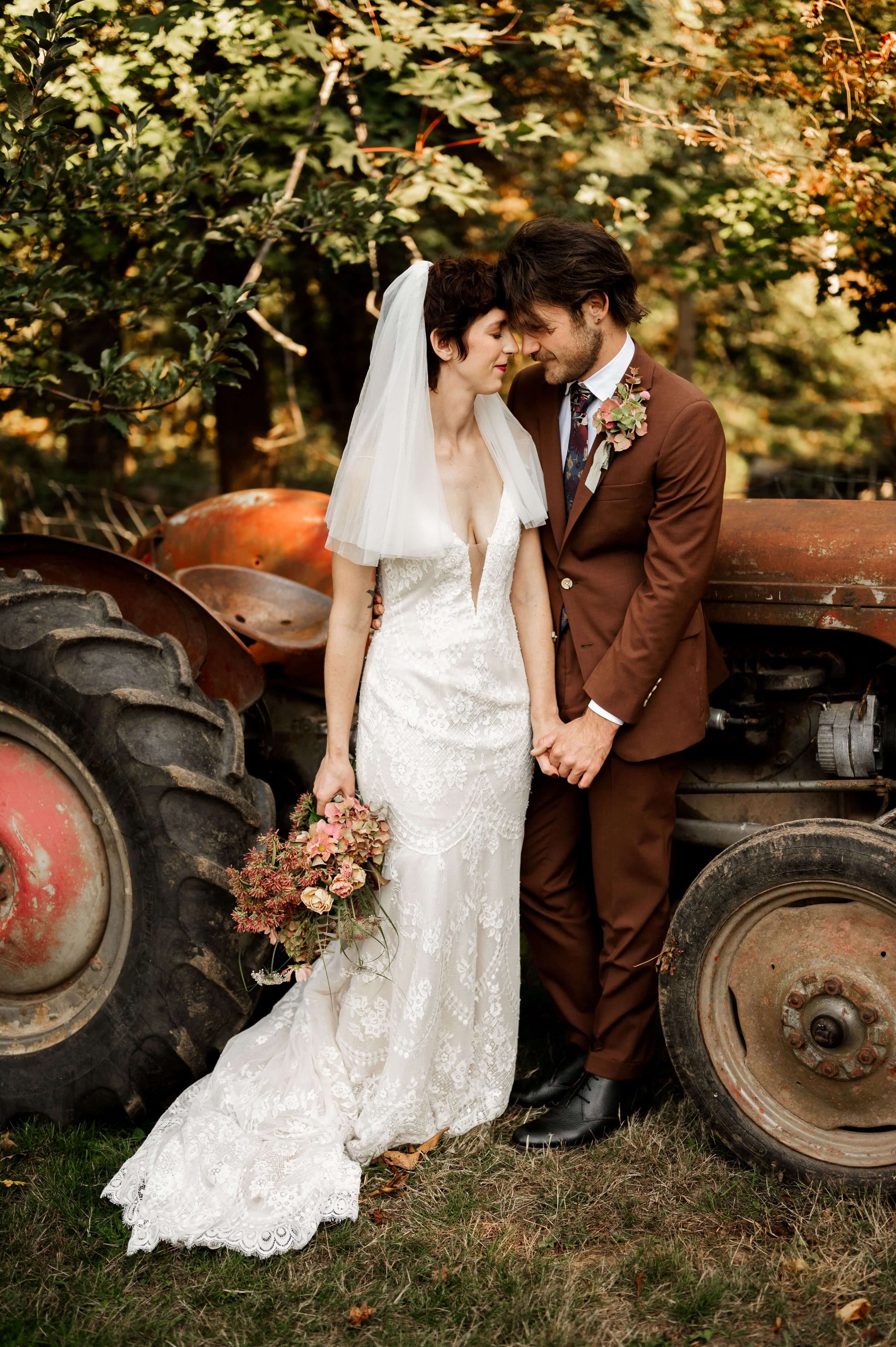 Fall wedding couple with vintage tractor and hydrangea bridal bouquet — rustic wedding florals by Kvetka Flower, Oregon