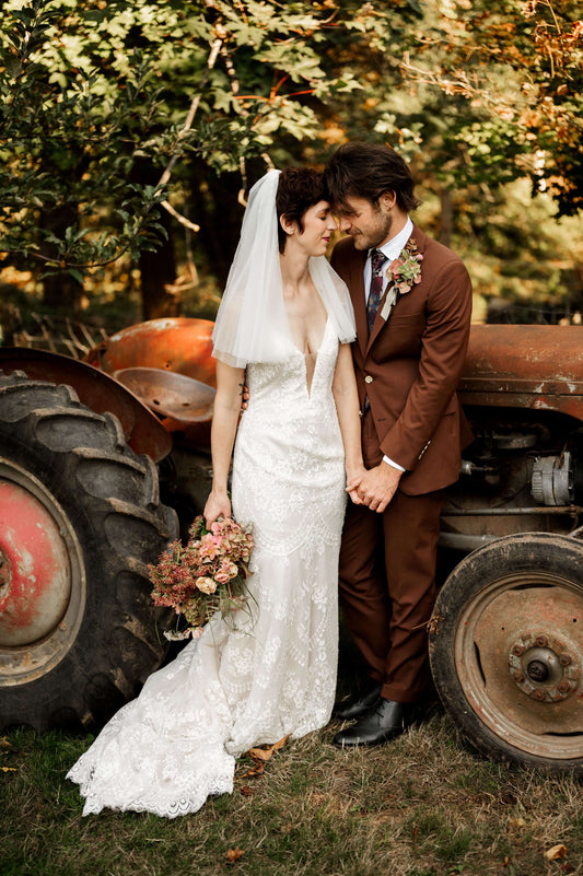 Fall wedding couple with vintage tractor and hydrangea bridal bouquet — rustic wedding florals by Kvetka Flower, Oregon