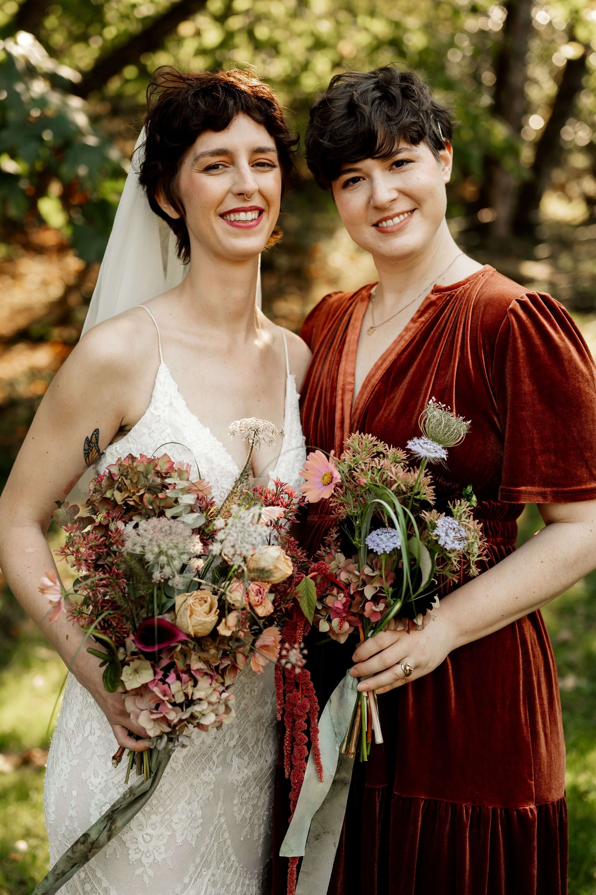Bride and bridesmaid holding moody fall bouquets with hydrangeas and wildflowers — Kvetka Flower, Oregon wedding