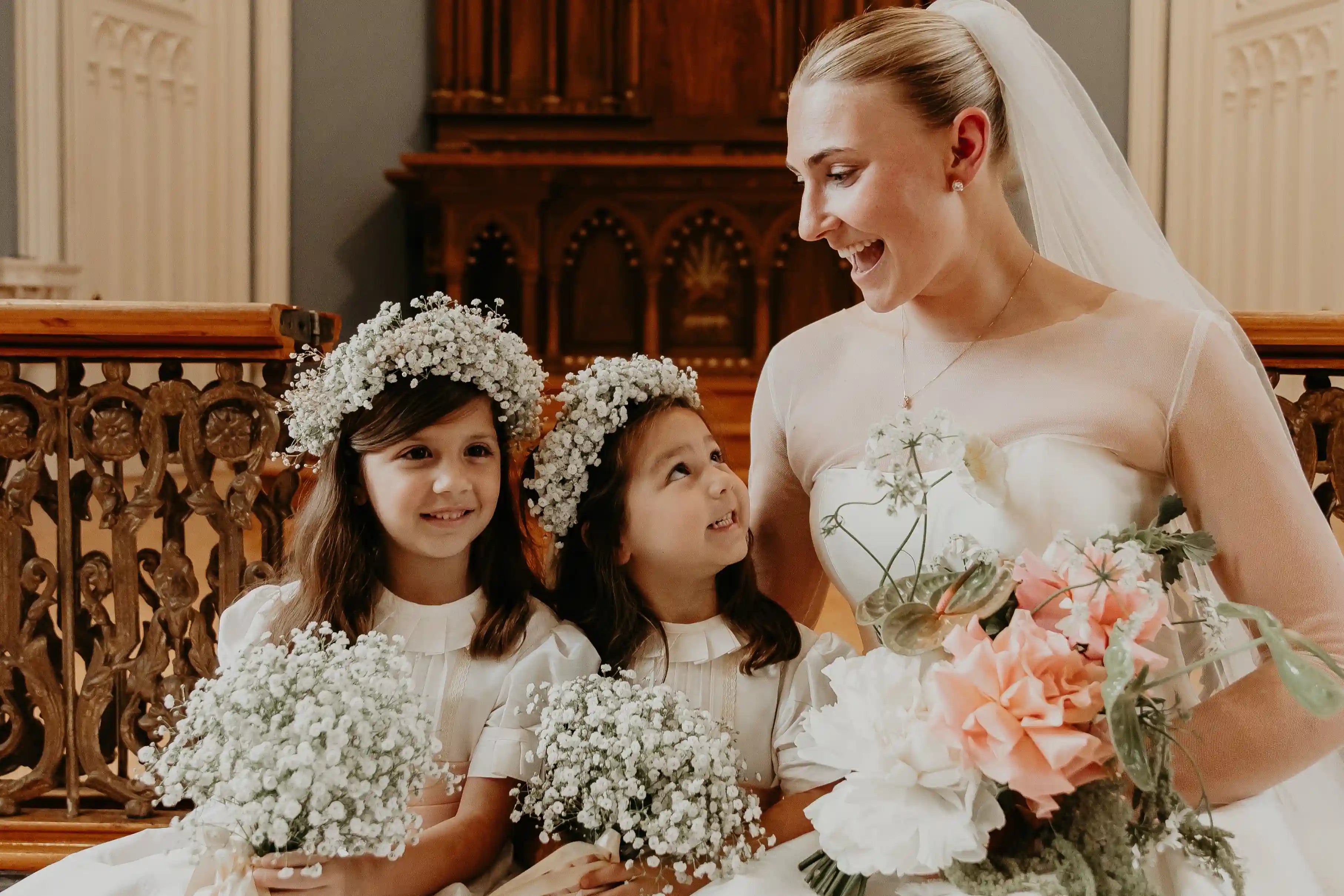 Bride with flower girls holding baby’s breath bouquets and wearing floral crowns — featuring a handcrafted bridal bouquet by Kvetka Flower in Portland
