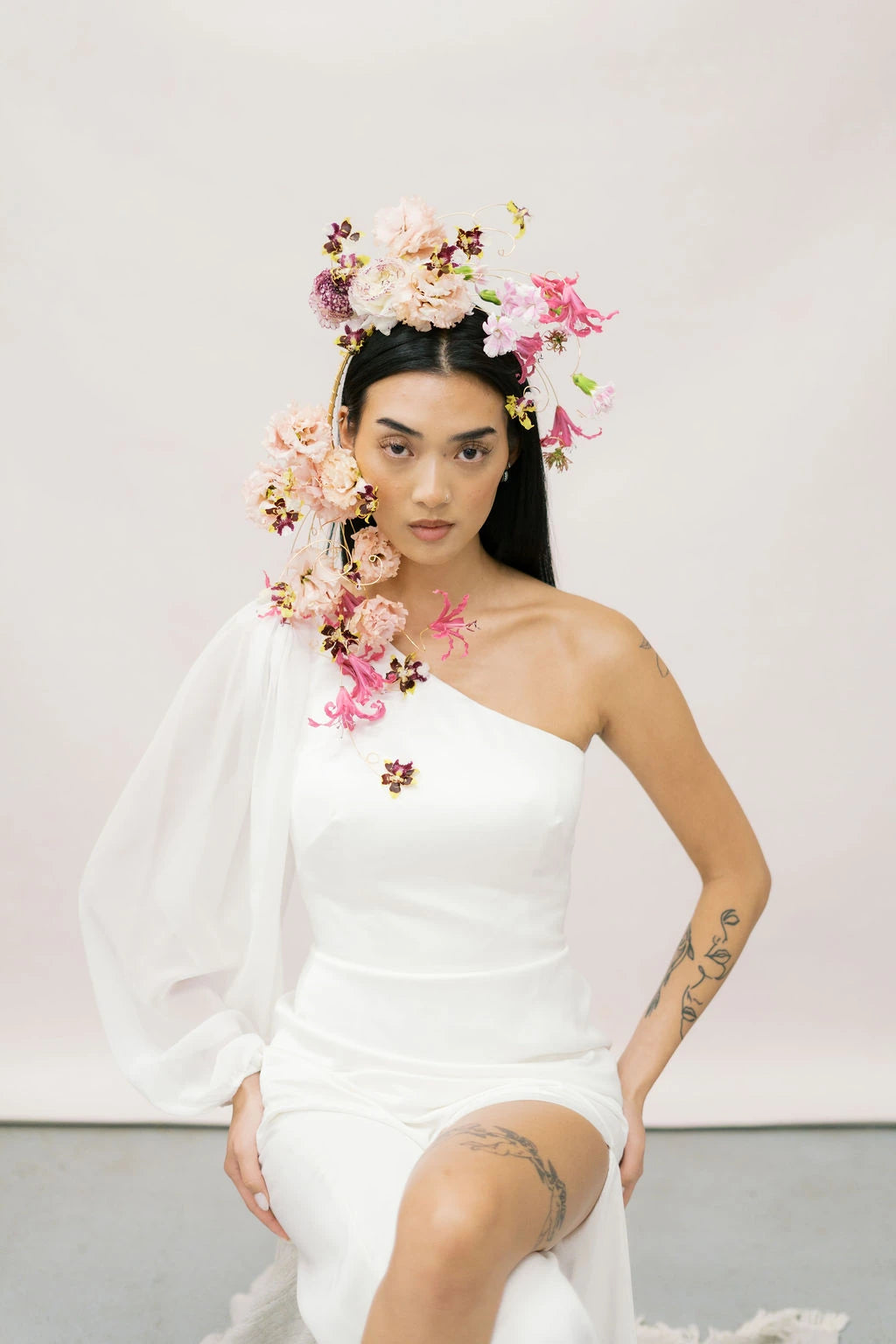 Bride wearing cascading flower crown with lisianthus and nerine flowing down shoulder by Kvetka Flower Portland