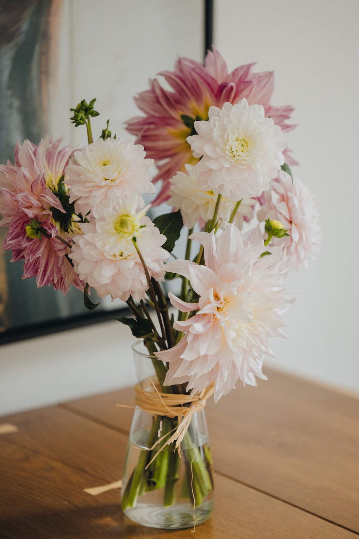Dahlia bouquet in soft tones on a wooden table, designed by Kvetka Flower in Portland OR