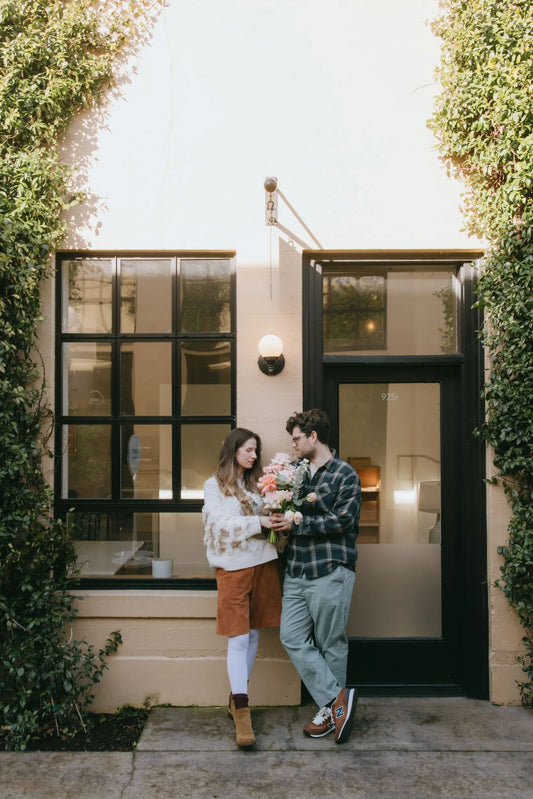 Couple with premium pink bouquet at Portland storefront