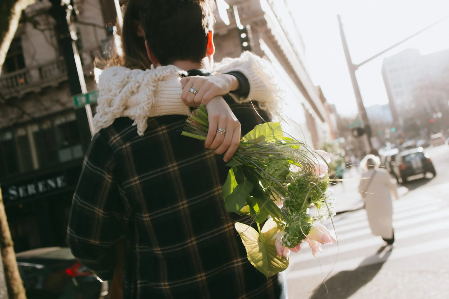 Couple hugging with premium green bouquet in Portland