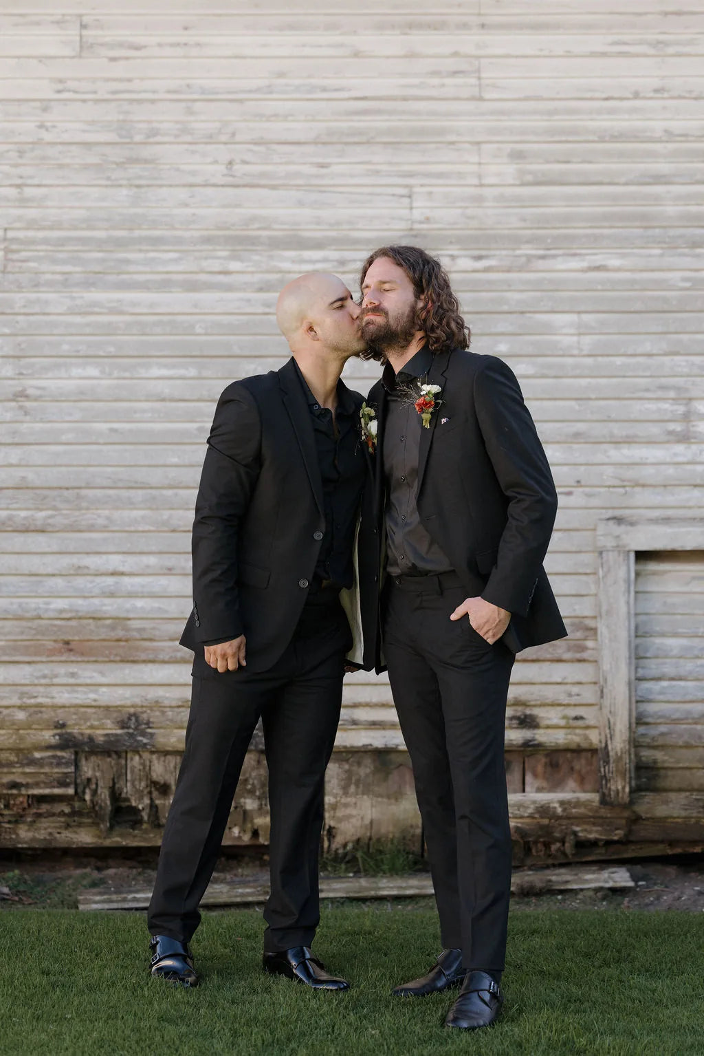 Groom wearing a rust colored dahlia boutonniere for a fall garden wedding at Langdon Farms.
