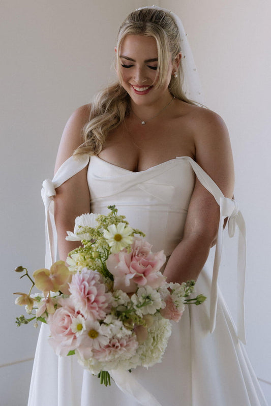 Bridal bouquet by Kvetka Flower featuring pink dahlias, orchids, and cosmos for a wedding in Portland.