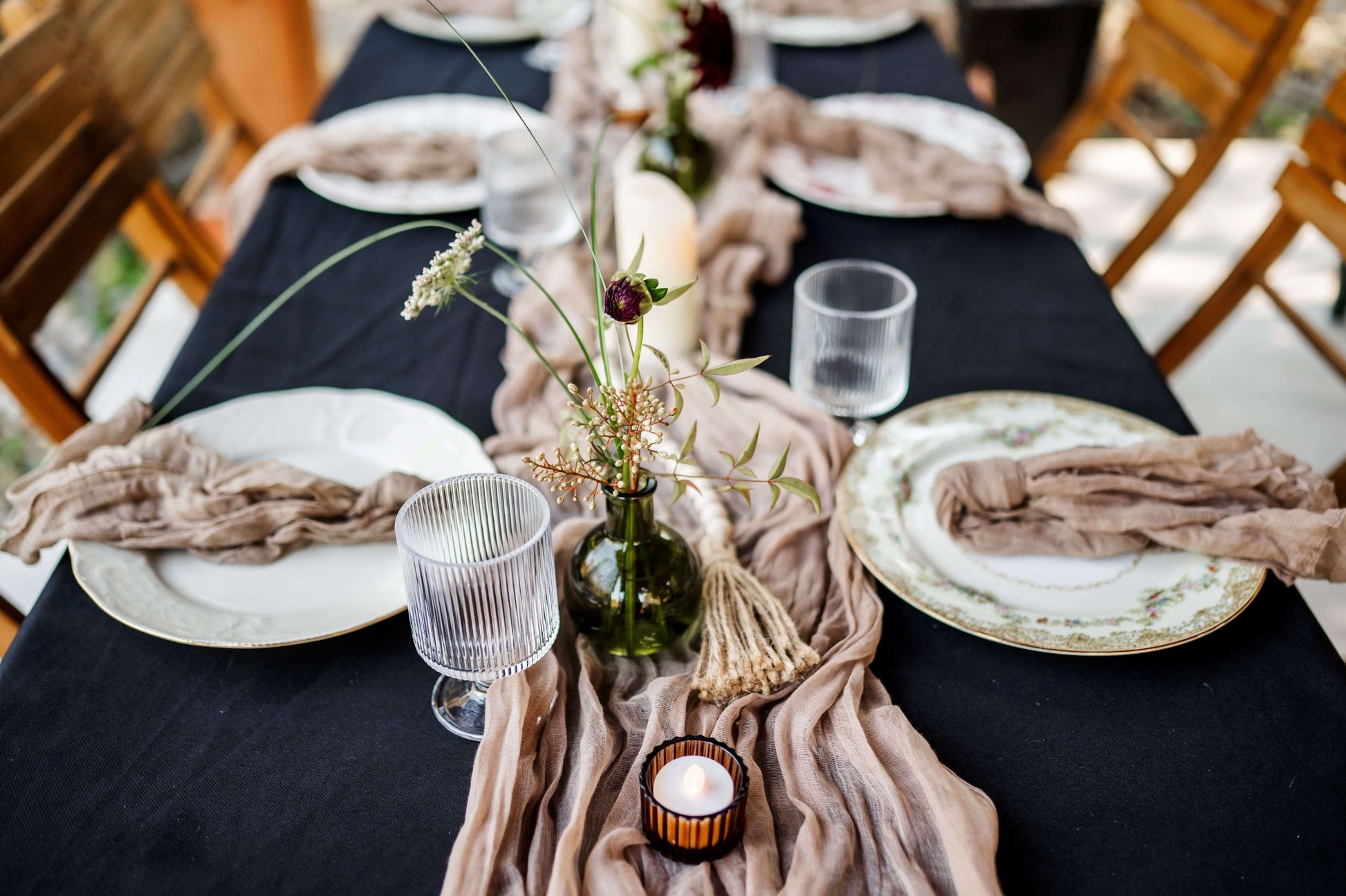 Rustic table setup with bud vases, black linen, and vintage plates — intimate fall wedding floral decor by Kvetka Flower