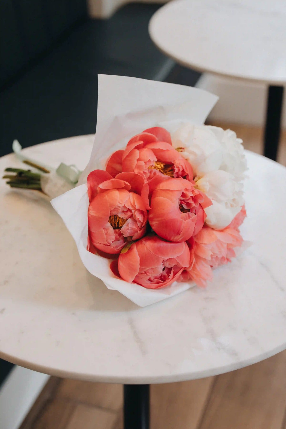 Bright coral peony bouquet in vase, local summer flowers florist
