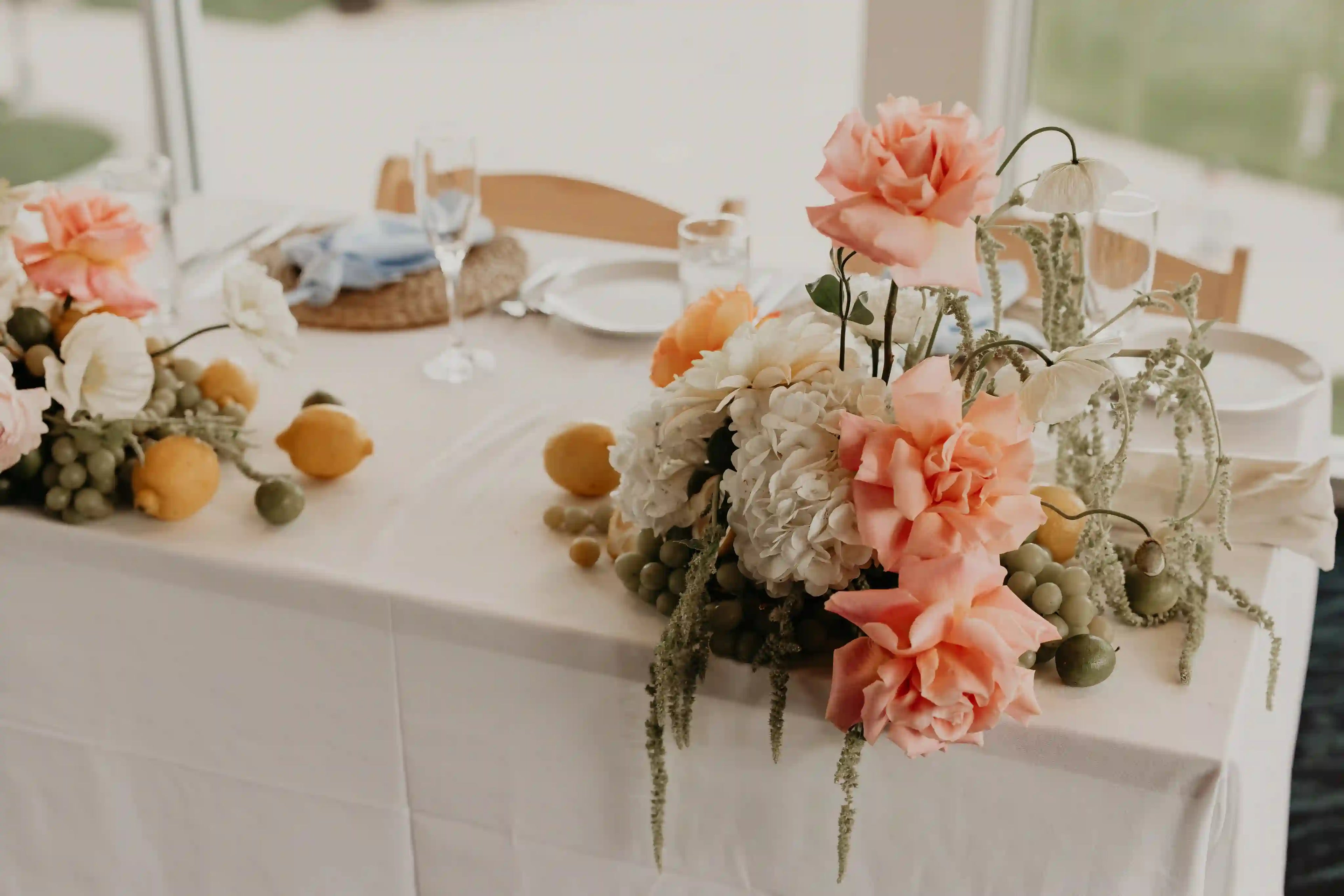 Sweetheart table centerpiece with peonies, French garden roses, and fresh fruits — custom wedding flowers by Kvetka Flower in Portland, OR