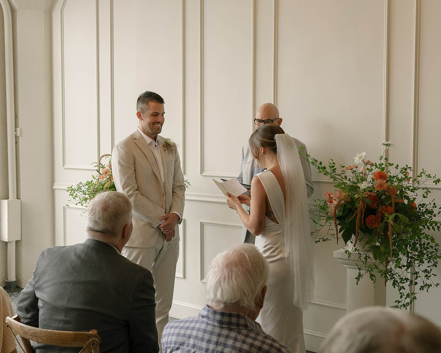 Bride reading vows to groom at Tendue in front of ceremony florals by Kvetka Flower