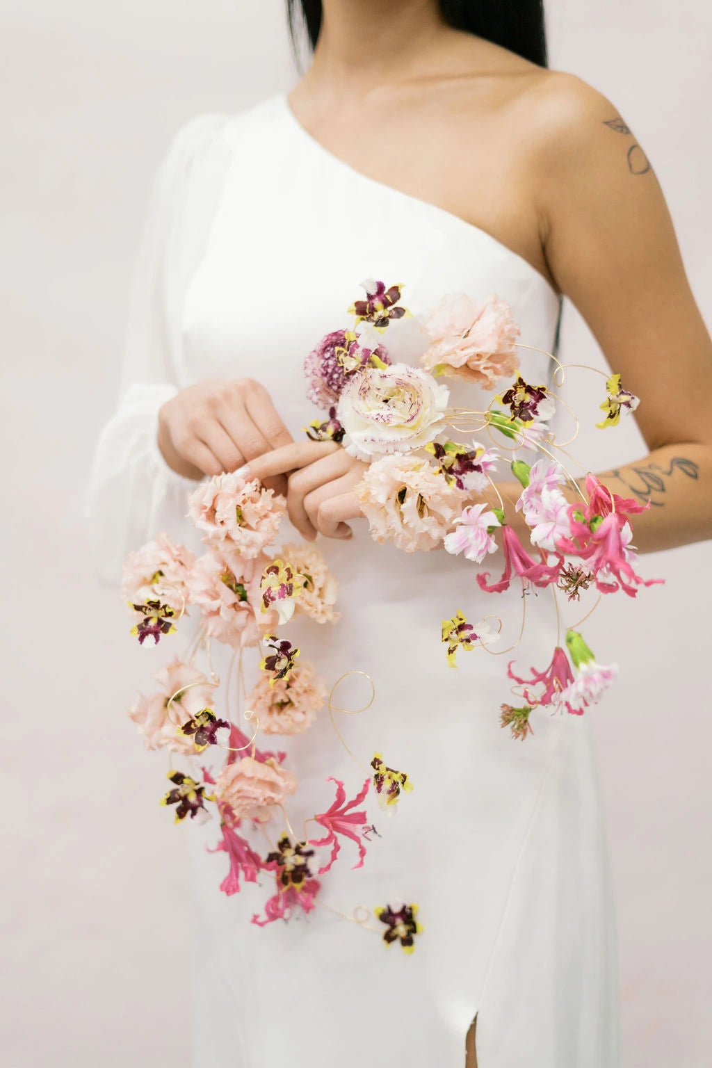 Detail shot of cascading bridal bouquet with gold wire structure and pink nerine flowers Austin wedding florist