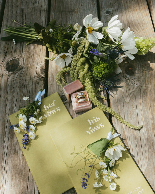 Wedding vow books, rings and delicate bridal flowers styled by Kvetka Flower Portland OR