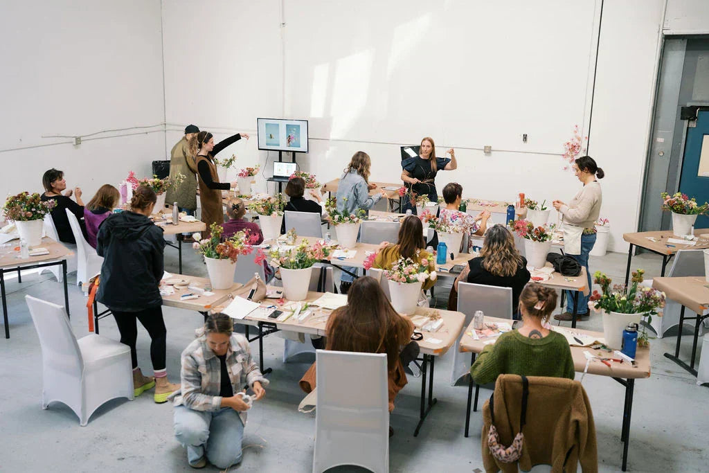 Florists learning wire armature techniques at Mayesh wholesale floral workshop in Portland Oregon