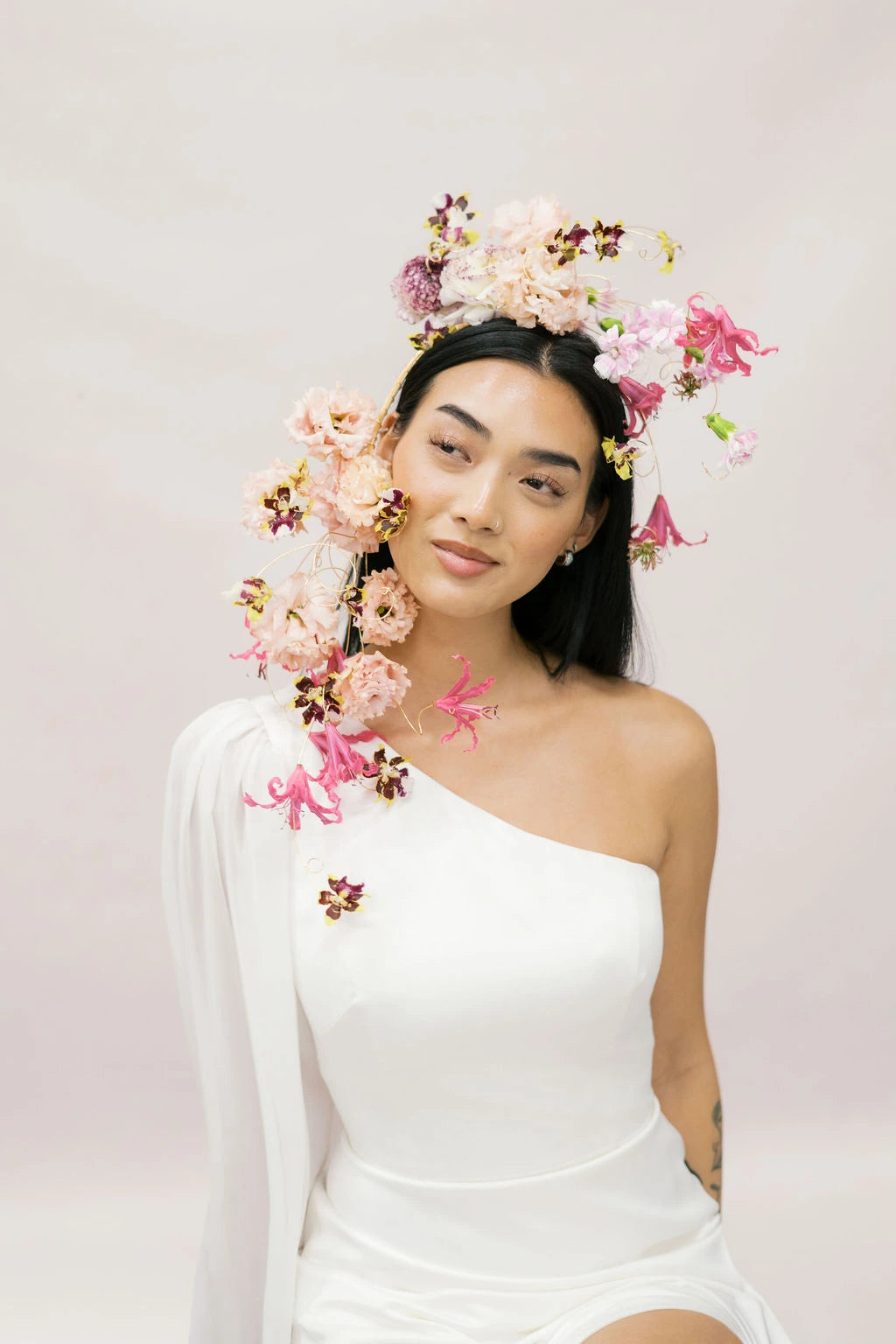 Smiling bride portrait with sculptural cascading flower crown in blush pink and fuchsia by Kvetka Flower Portland