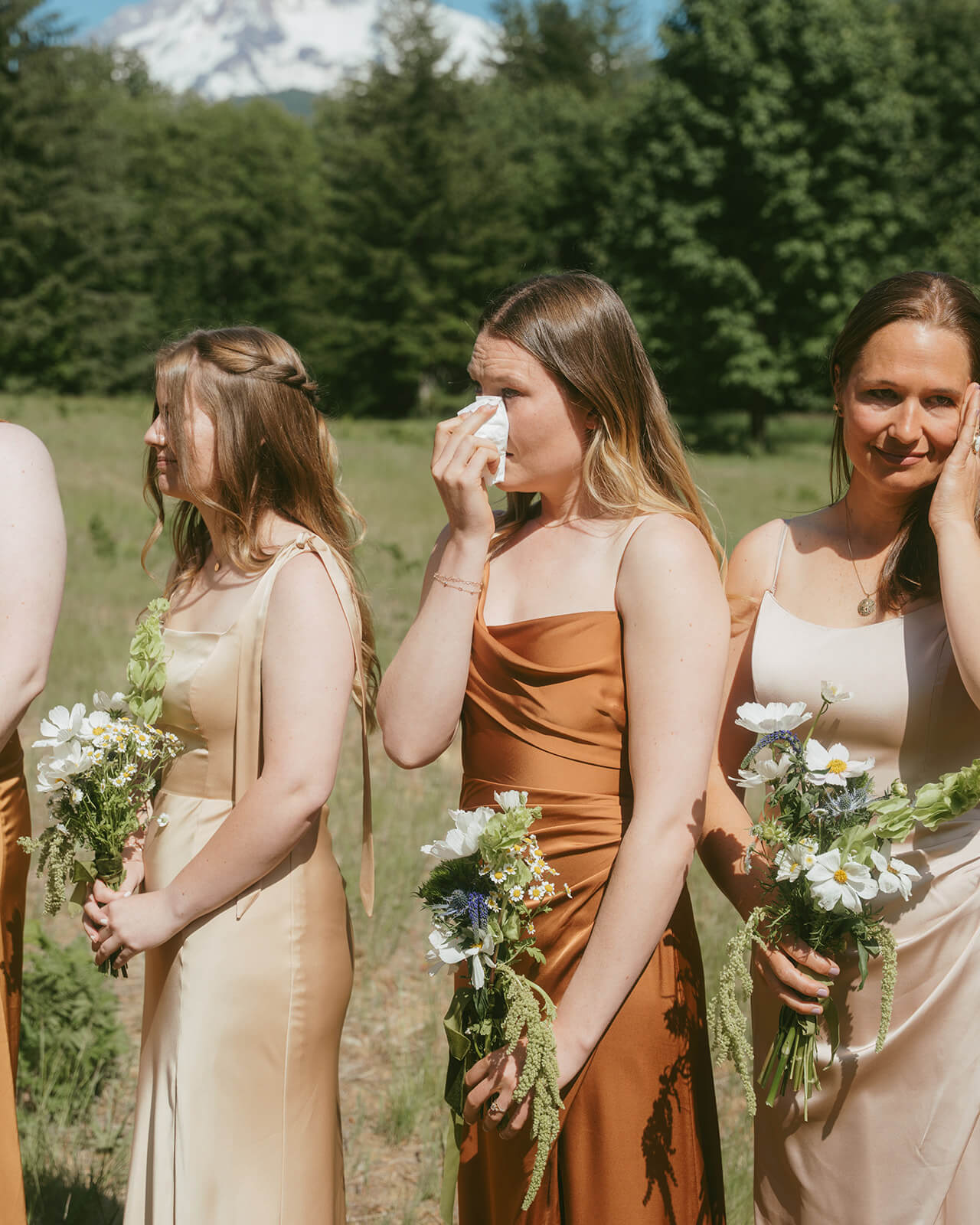 Bridesmaids holding rustic white and green bouquets at mountain wedding by Kvetka Flower Portland OR