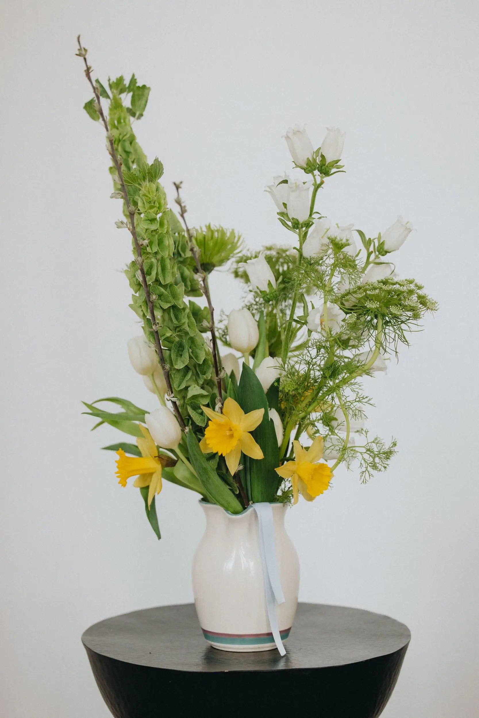 Medium custom bouquet artistic style with spring blooms daffodils and campanula hand-arranged by Portland florist Kvetka Flower
