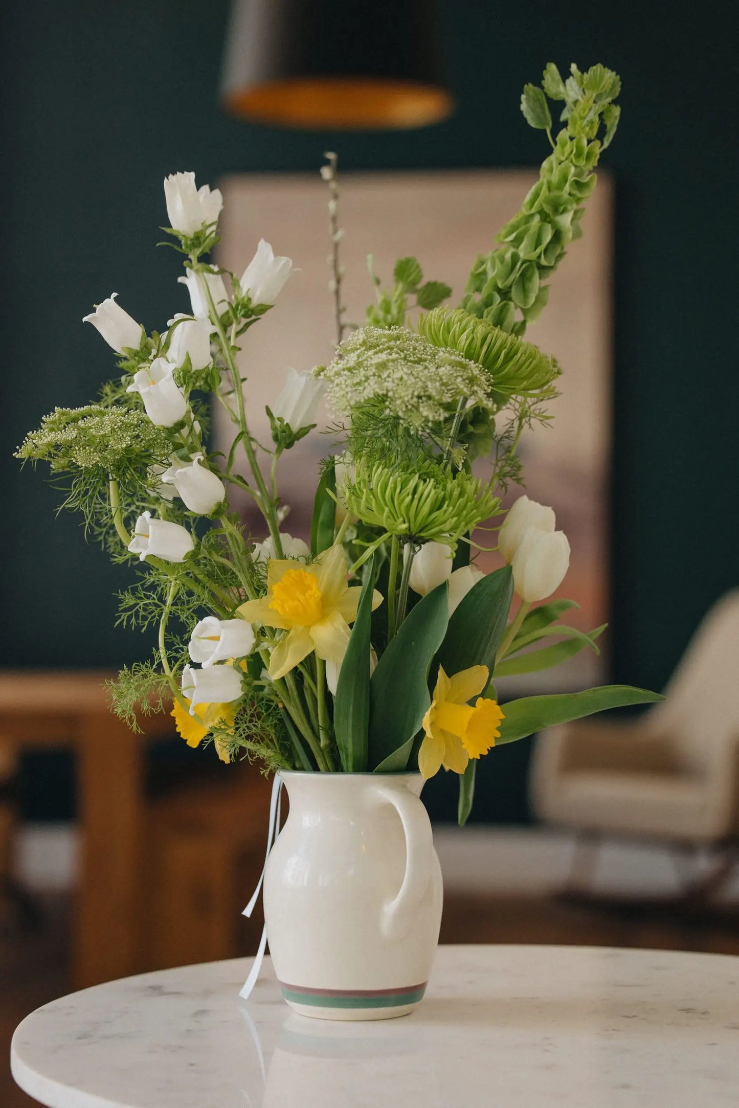 Custom flower bouquet medium with daffodils white tulips and bells of Ireland in ceramic vase by Kvetka Flower Portland Oregon