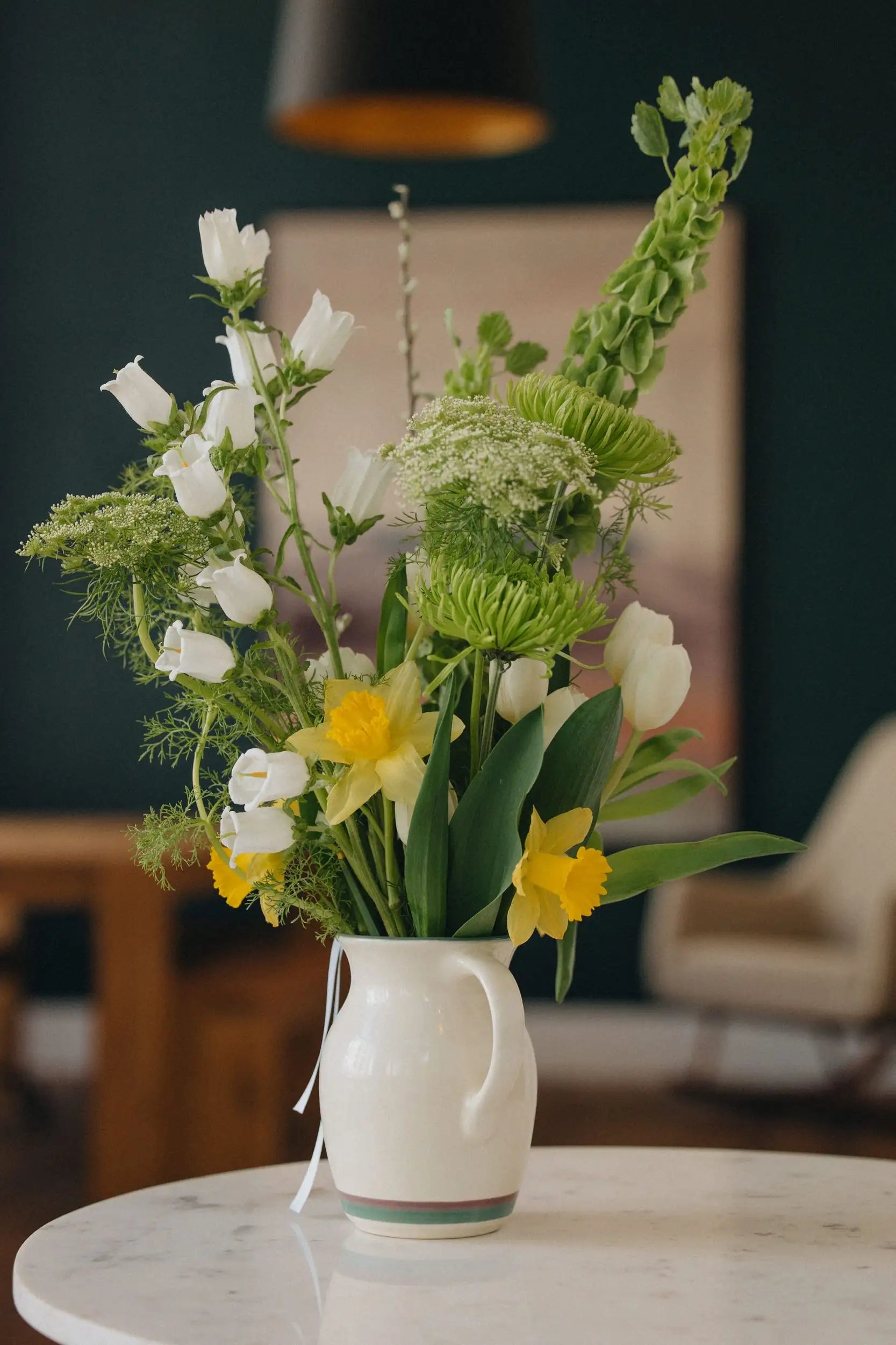 Custom flower bouquet medium with daffodils white tulips and bells of Ireland in ceramic vase by Kvetka Flower Portland Oregon