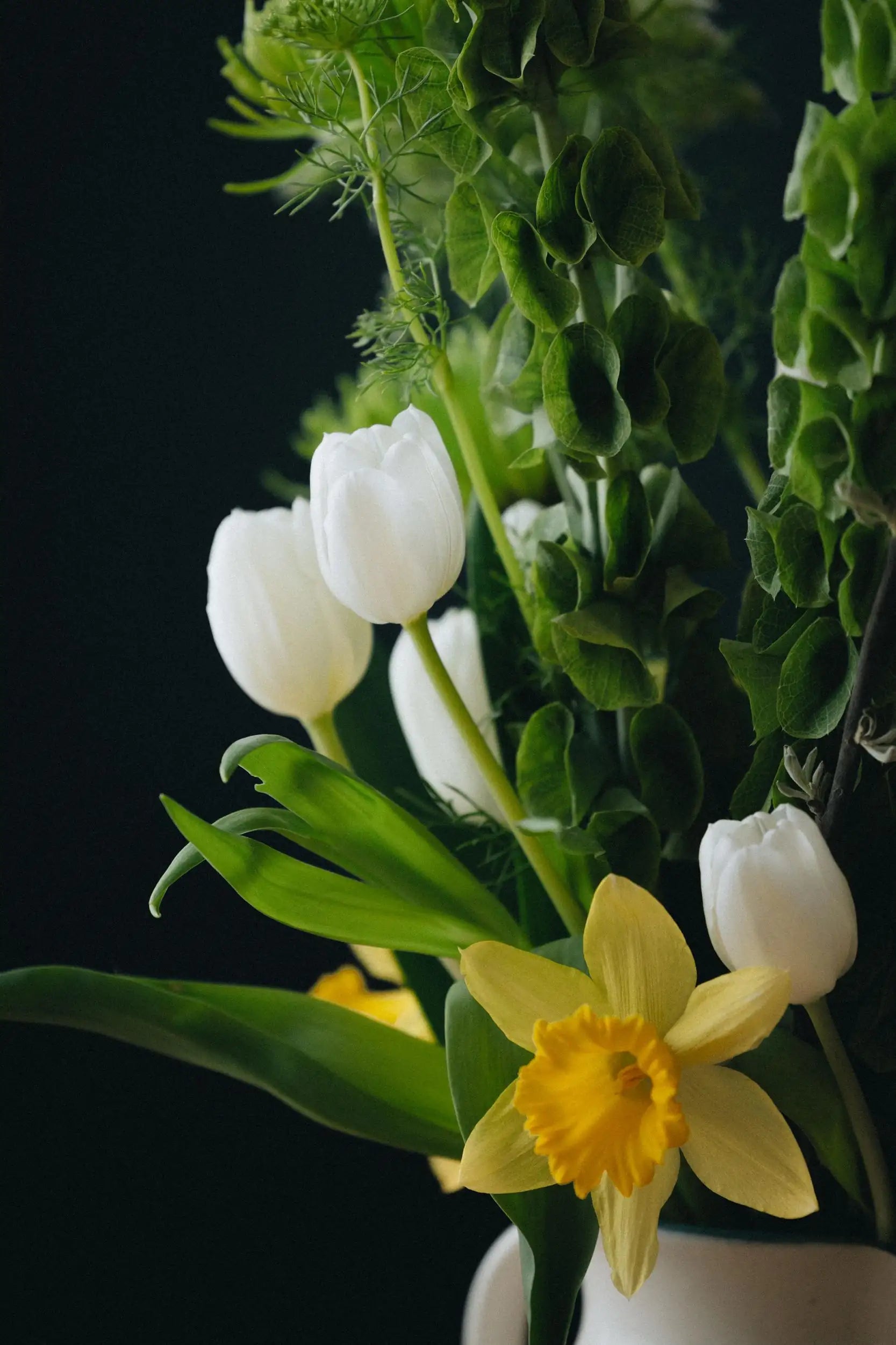 Unique custom bouquet detail white tulips yellow daffodil and bells of Ireland by Portland florist Kvetka Flower