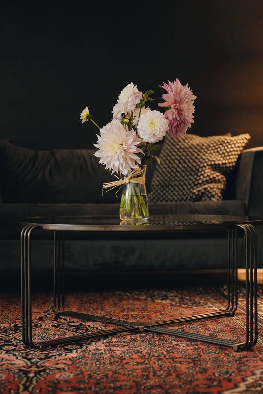 Elegant dahlia arrangement on a coffee table in a moody interior, Portland OR flower delivery