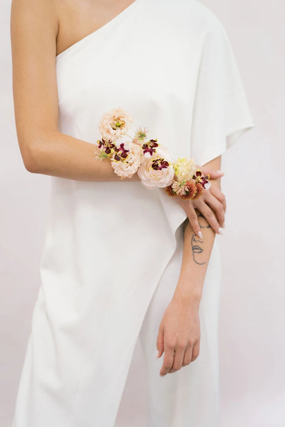 Sculptural wrist-to-forearm corsage with lisianthus and orchids on bride by Portland wedding florist Kvetka