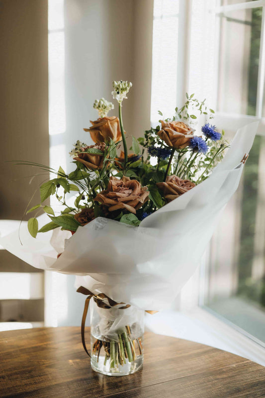 Close-up of blue cornflowers and caramel-toned roses in the Evening Letter bouquet, Portland florist