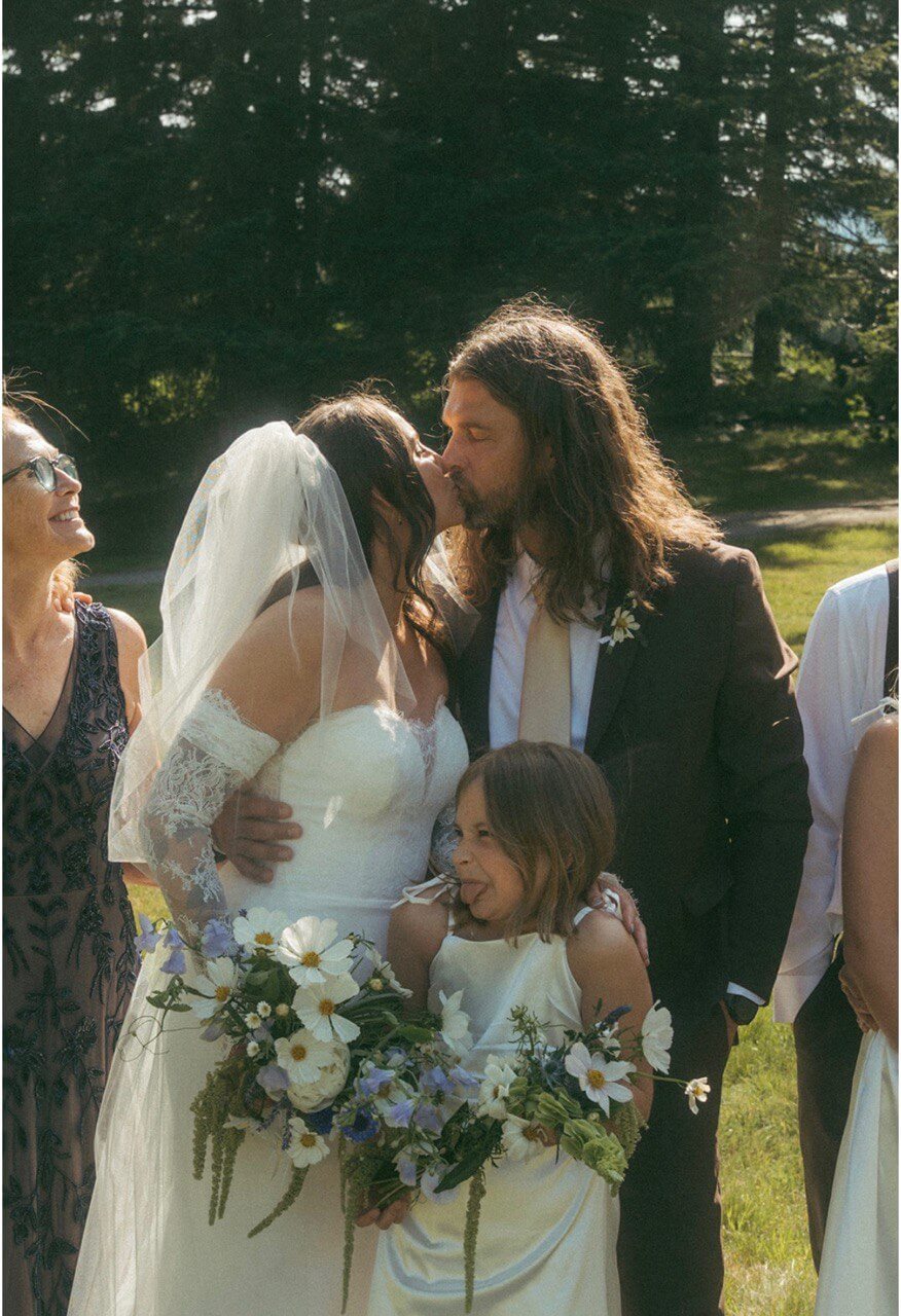 Family photo with bride and groom holding bouquets of fresh wedding flowers by Kvetka Flower Portland OR