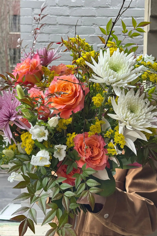 Close-up fresh seasonal bouquet orange roses spider mums solidago Portland florist Kvetka Flower