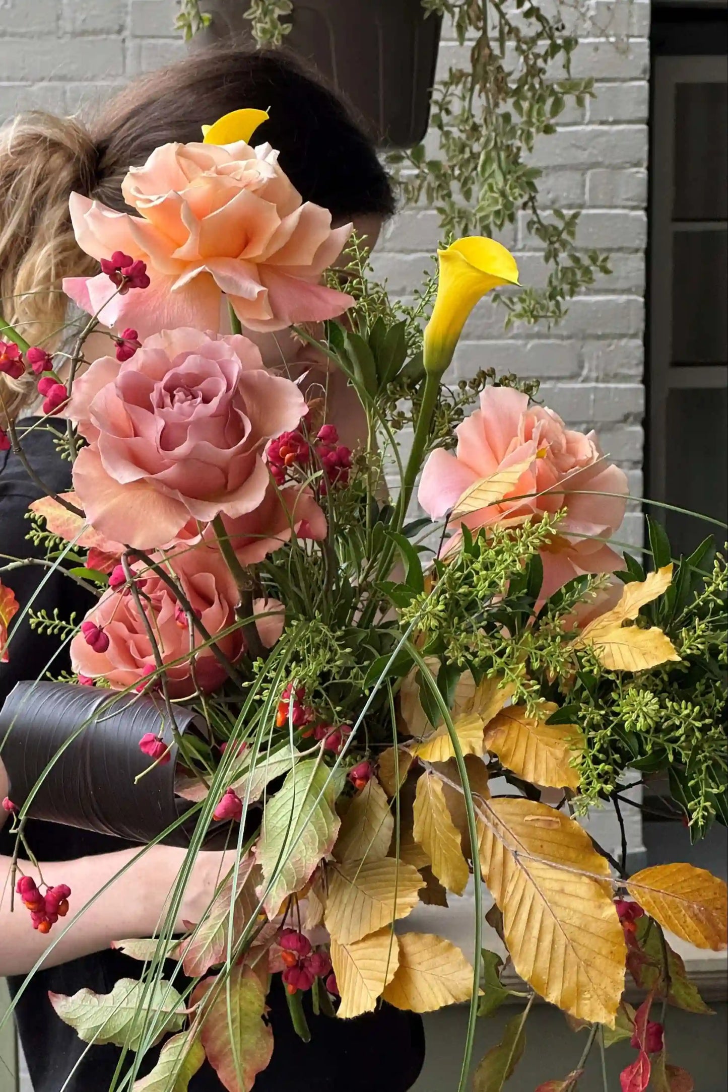 Medium seasonal bouquet with peach roses yellow calla lilies autumn foliage hand-designed by Kvetka Flower Portland Oregon florist