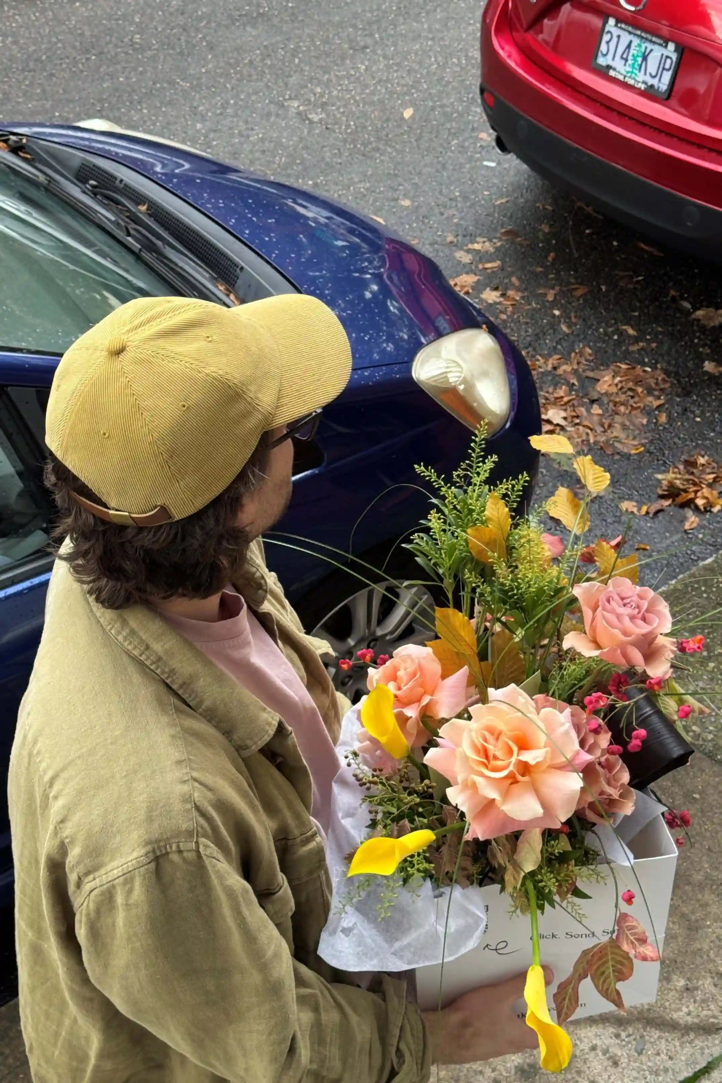 Medium seasonal rose bouquet with yellow calla lilies autumn leaves hand-crafted by Portland Oregon florist Kvetka Flower