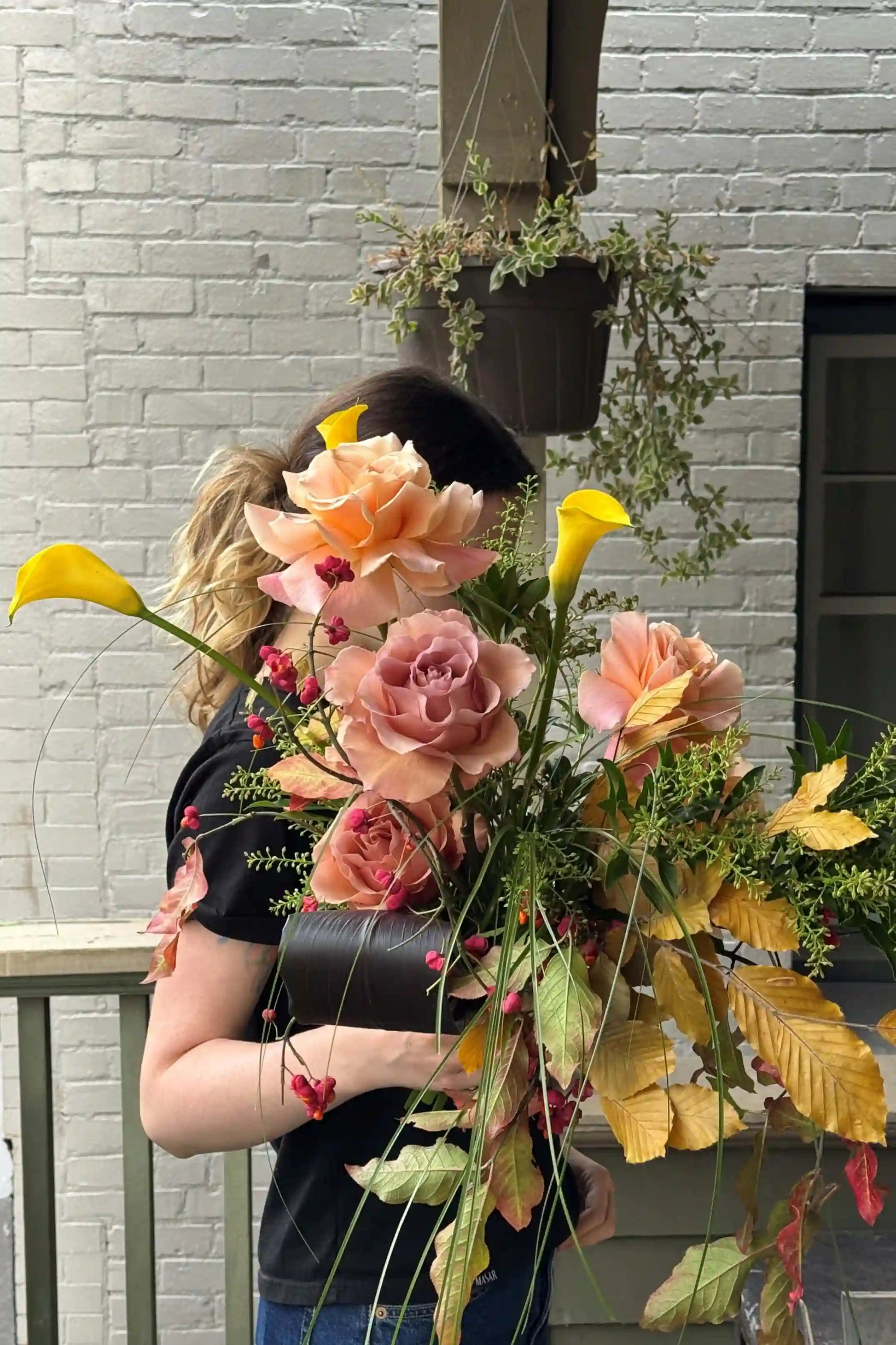 Medium seasonal bouquet with peach roses yellow calla lilies red berries autumn leaves by Kvetka Flower Portland Oregon florist