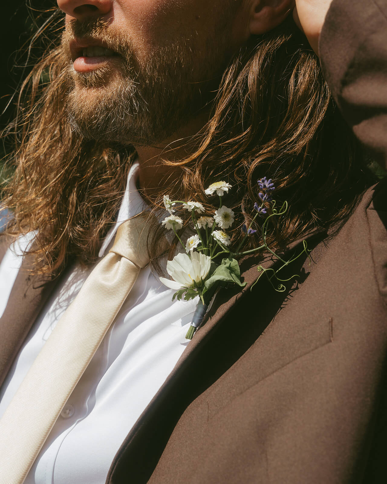 Close-up of groom wearing wildflower boutonniere by Kvetka Flower Portland OR
