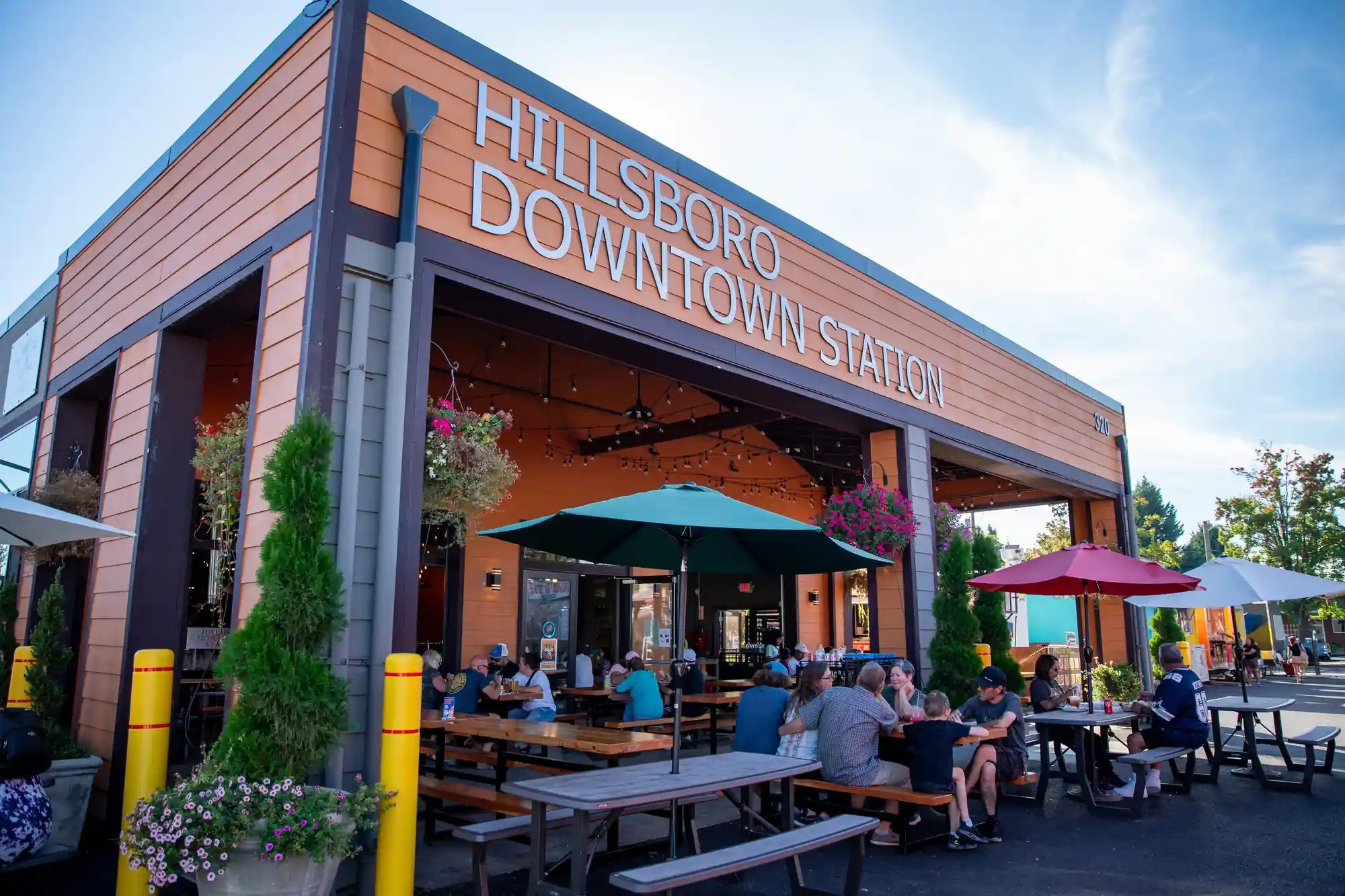 Hillsboro Downtown Station outdoor patio with hanging flowers and greenery — same-day flower delivery to Hillsboro by Kvetka Flower