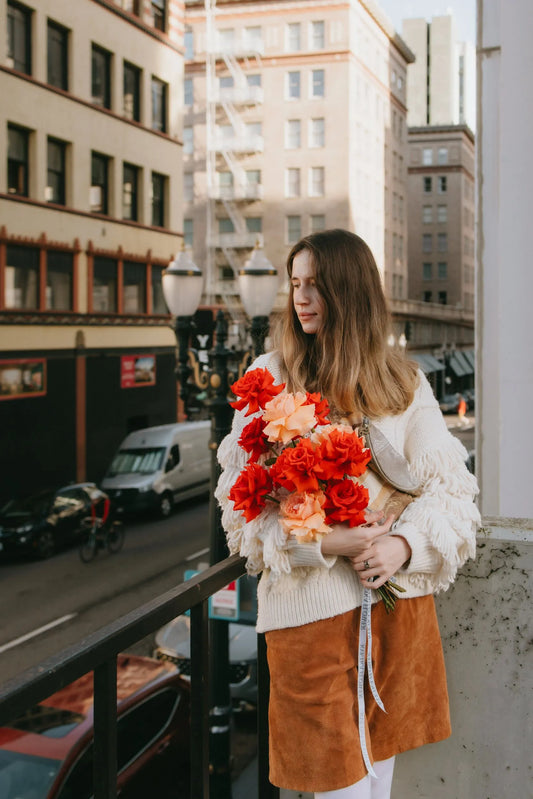 Woman with vibrant roses bouquet on Portland street
