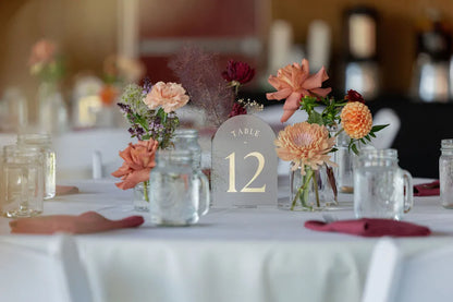 Bud vase wedding centerpieces with dahlias and roses for a rustic table setting.