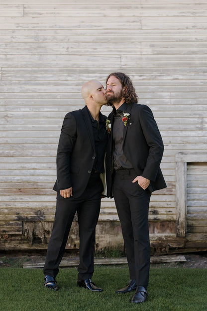 Groom wearing a rust colored dahlia boutonniere for a fall garden wedding at Langdon Farms.