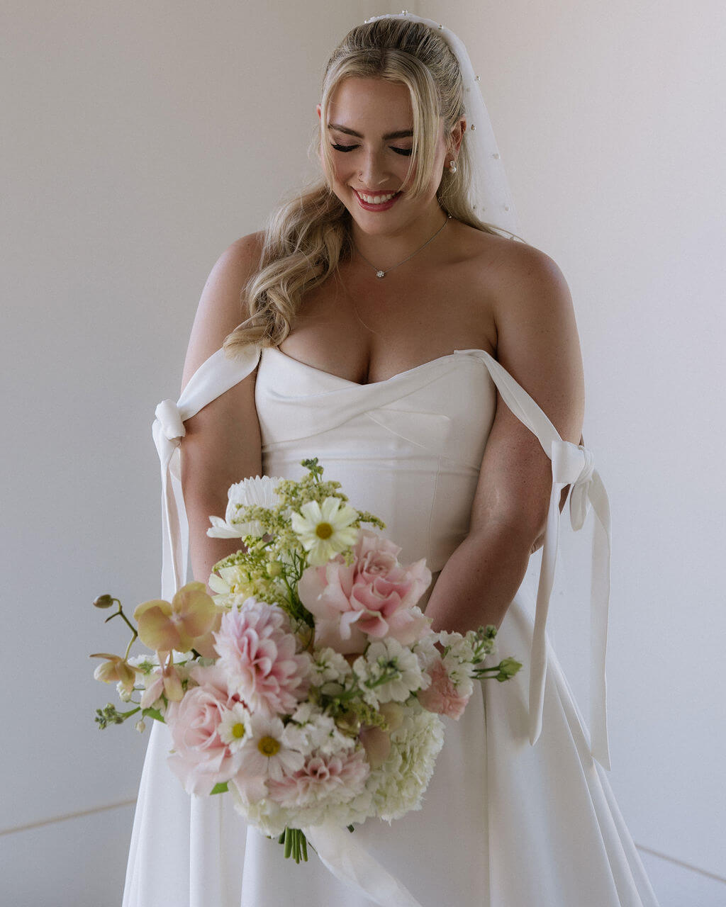 Bridal bouquet by Kvetka Flower featuring pink dahlias, orchids, and cosmos for a wedding in Portland.