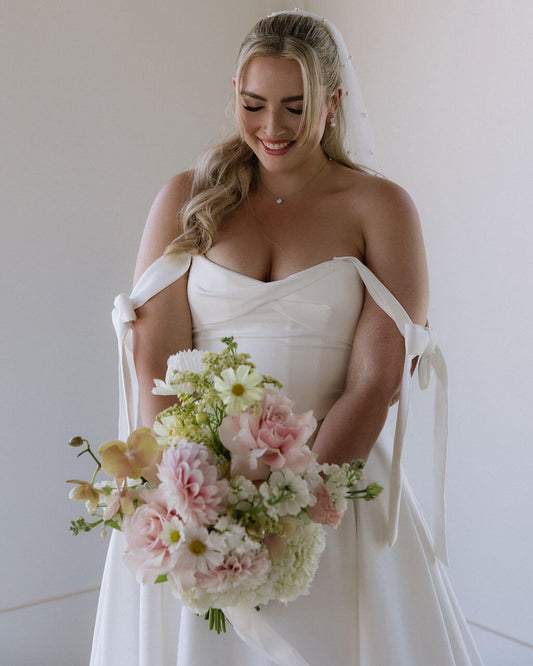 Bridal bouquet by Kvetka Flower featuring pink dahlias, orchids, and cosmos for a wedding in Portland.