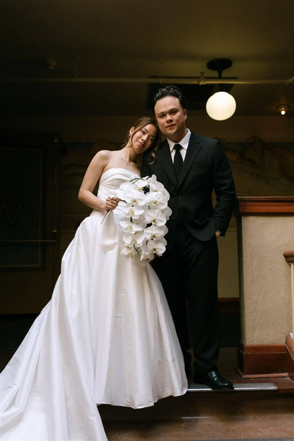 Bride and groom portrait with white phalaenopsis orchid bouquet by Kvetka Flower at McMenamins Edgefield Oregon