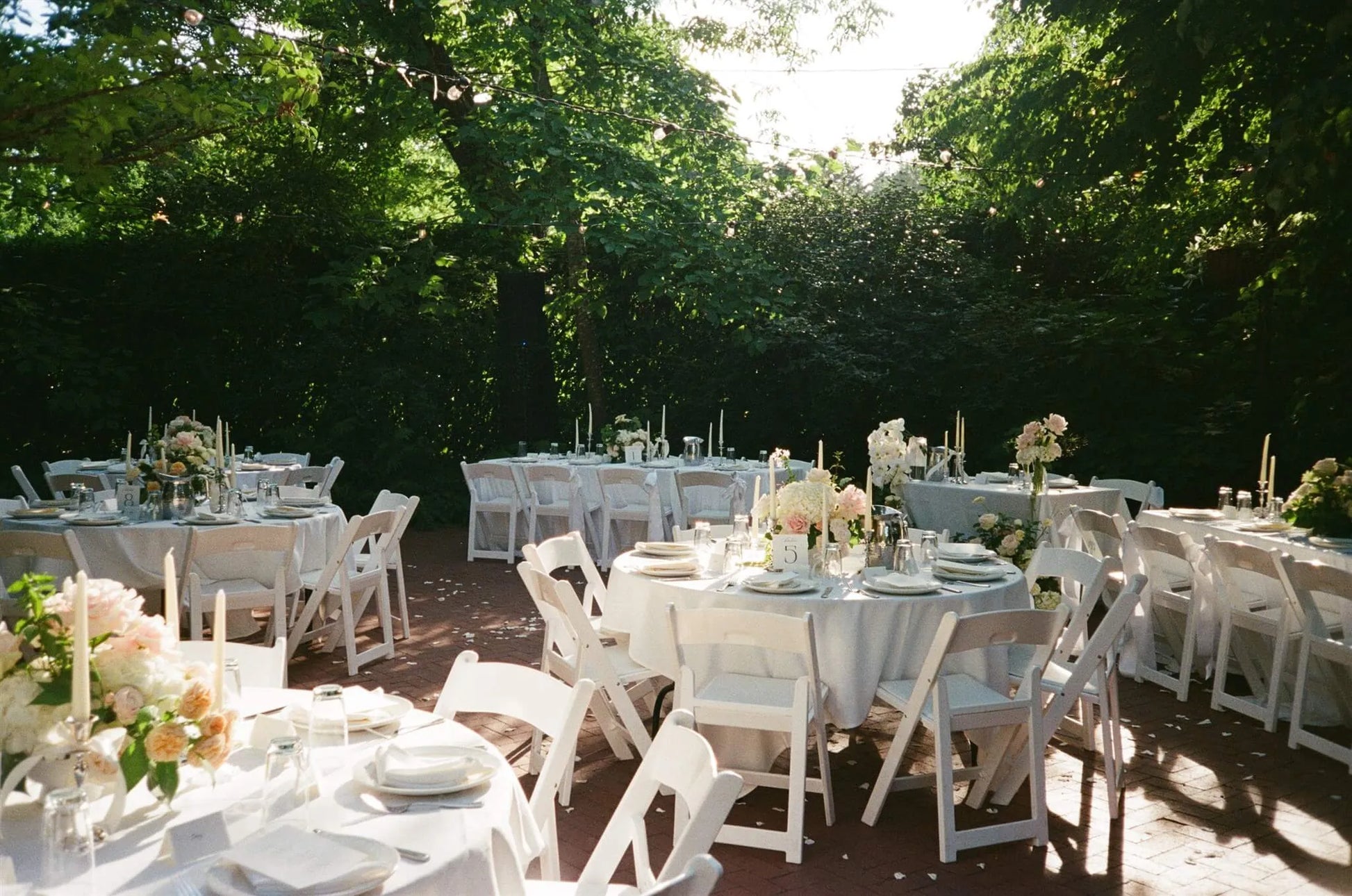 Outdoor garden reception with floral centerpieces on every table at McMenamins Edgefield wedding by Kvetka Flower