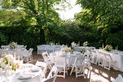Full reception overview with decorated guest tables under trees at McMenamins Edgefield by Kvetka Flower