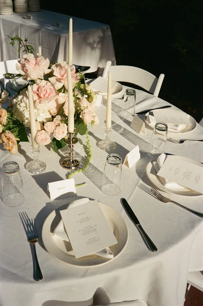 Round reception table with romantic rose centerpiece and taper candles by Portland wedding florist Kvetka Flower