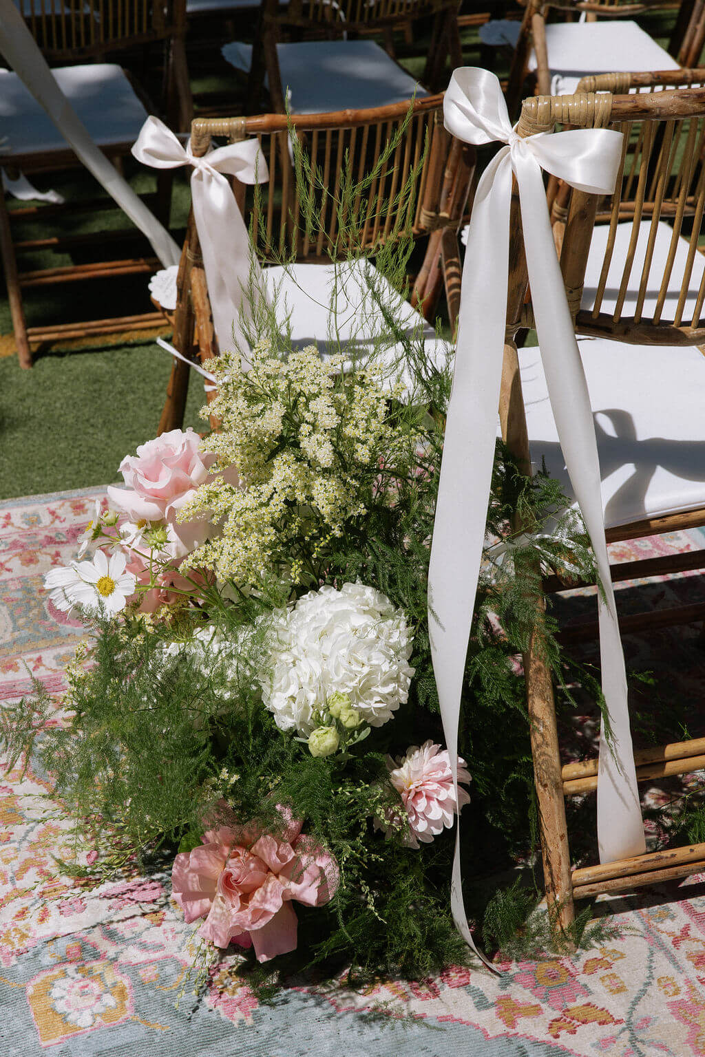 Wedding aisle decor with white hydrangea and roses by Kvetka Flower at Redland Family Farm in Oregon.