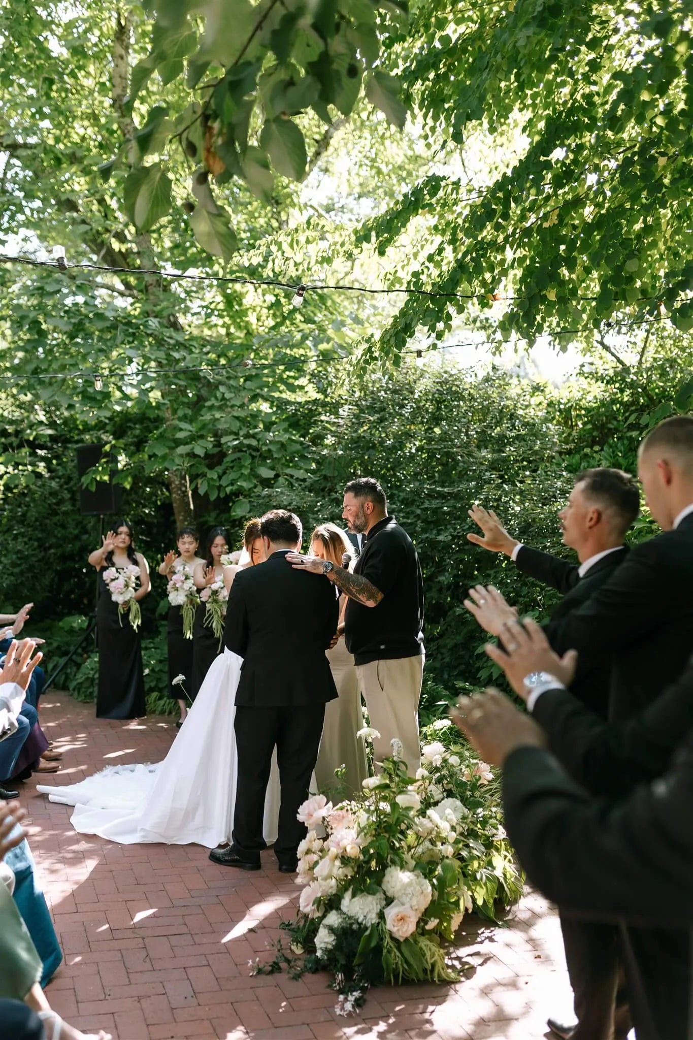 Outdoor wedding ceremony at McMenamins Edgefield with lush ground floral arrangements by Kvetka Flower Portland