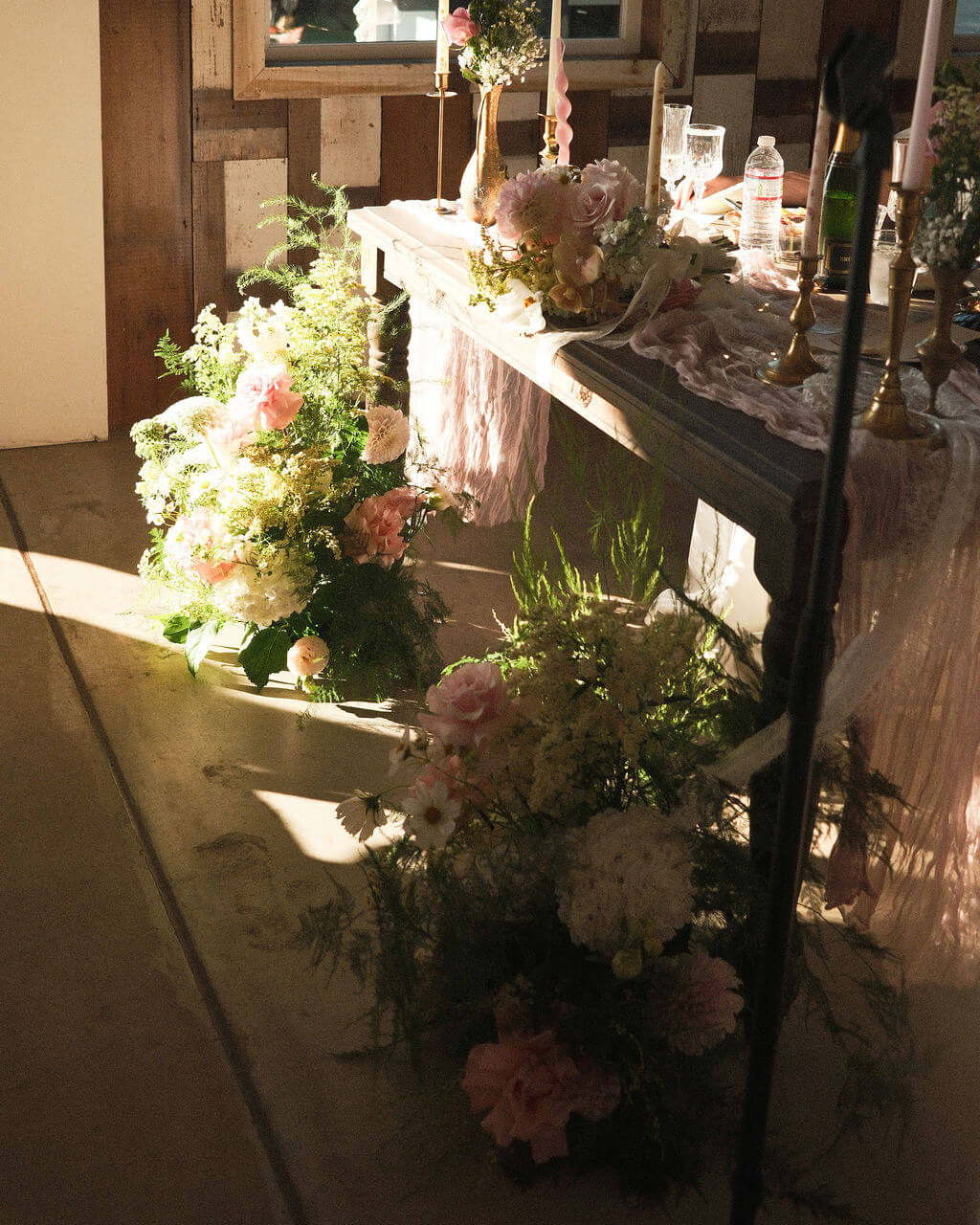 Floor floral arrangements by Kvetka Flower decorate the wedding reception at Redland Family Farm, Portland.