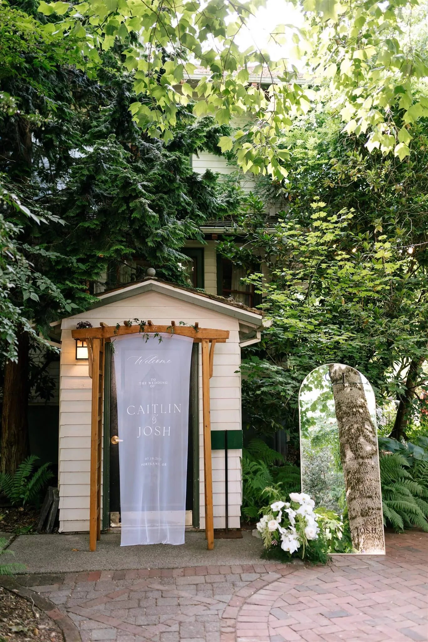 Wedding welcome sign with white floral arrangement accent at McMenamins Edgefield by Kvetka Flower Portland