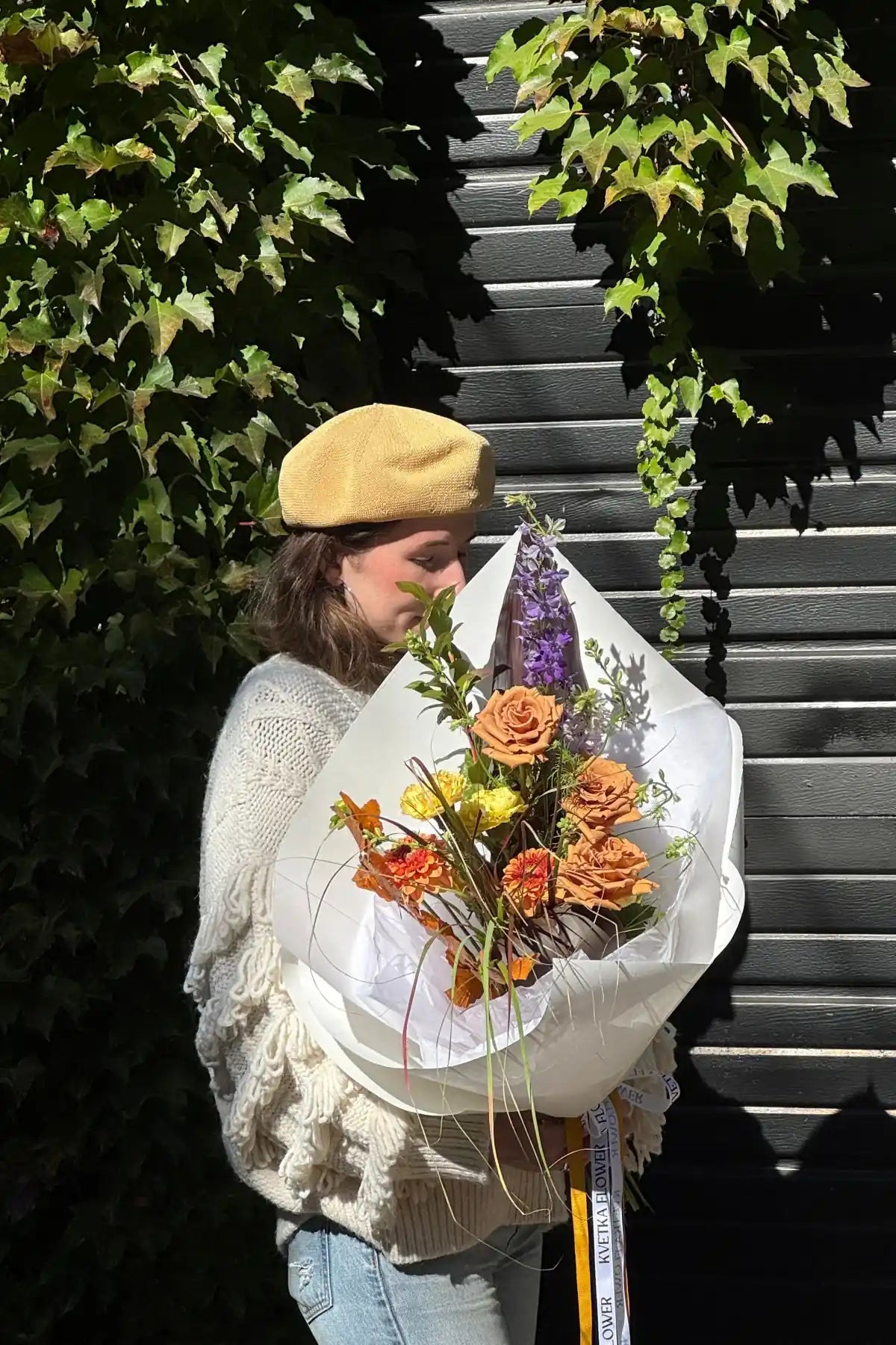 European-style seasonal flower bouquet small size with caramel roses, delphinium and autumn foliage wrapped in elegant white paper