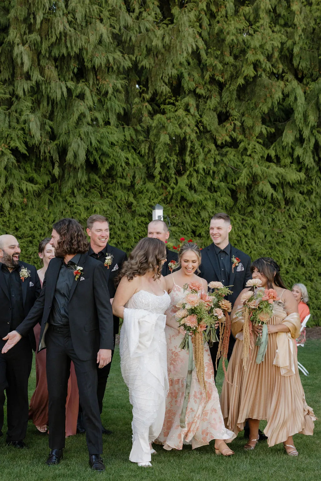 Joyful wedding party walking at a fall garden wedding in Oregon.