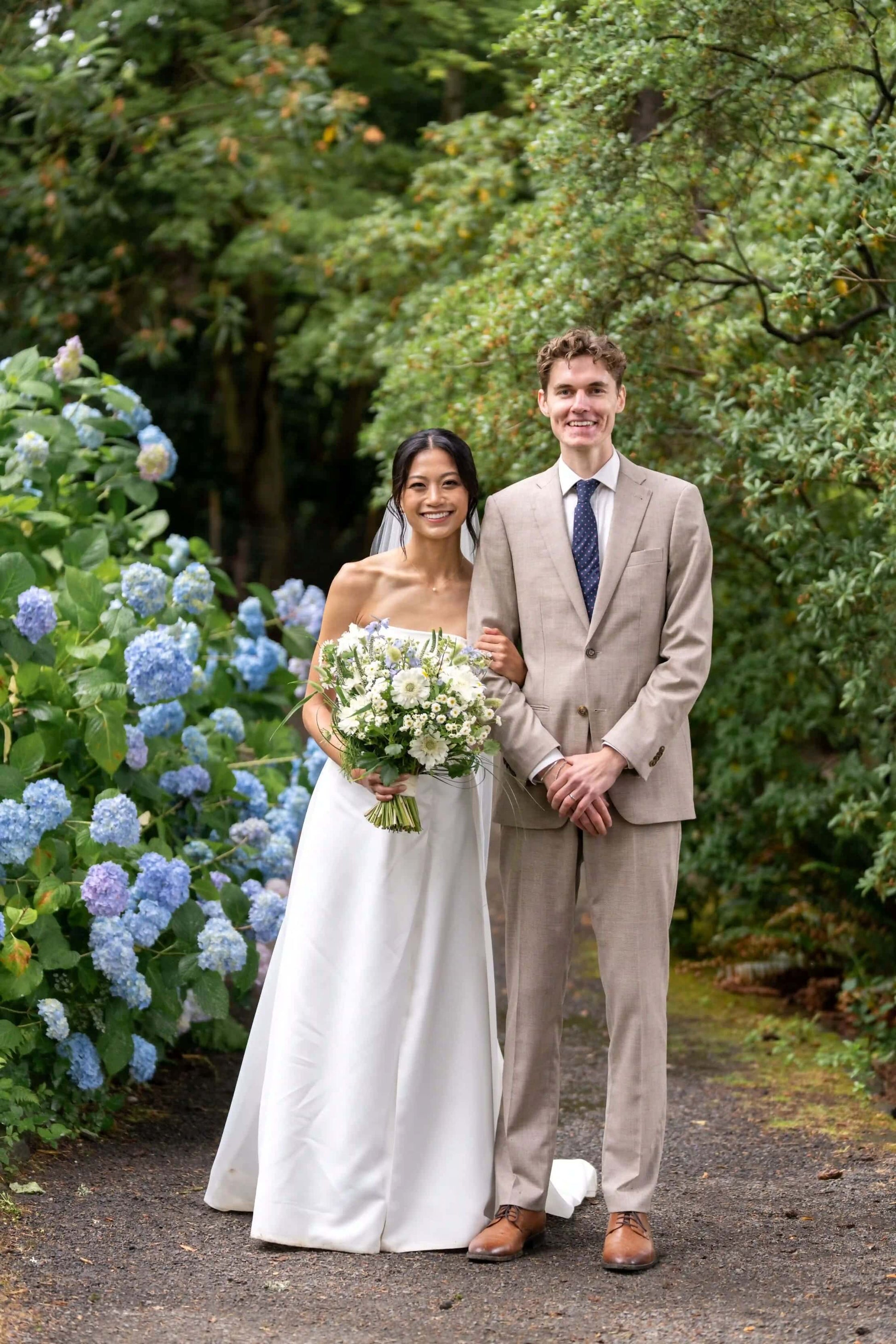 Bride and groom portrait with a large Kvetka Flower bouquet featuring white and pastel flowers in Portland, OR